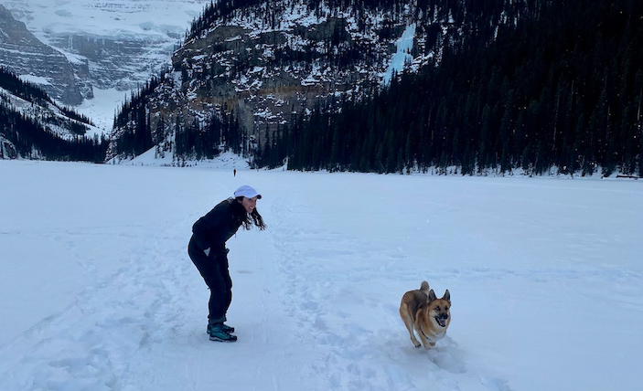 Katherine Long '15 in Tajikistan with a dog and snowy mountains in the background